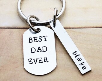 May include: Silver keyring with two tags. One tag says "Best Dad Ever" and the other tag says "Blake".