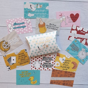 May include: A set of colorful cards with French text, each card depicting a different activity or task. The cards are arranged on a light wood surface. The text on the cards includes "Bon pour un massage", "Bon pour une nuit compl&egrave;te", "Bon pour passer mon tour pour le biberon", "Bon pour passer mon tour pour le bain", "Bon pour se faire servir le petit d&eacute;j au lit", "Bon pour un calin", "Bon pour une soir&eacute;e en amoureux", "Bon pour un gros mot", "Bon pour une soir&eacute;e on fait un autre b&eacute;b&eacute;!" and "Les p'tits bons du jeune papa".