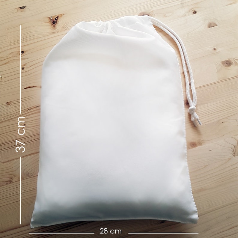 May include: A white drawstring bag made of fabric, measuring 28 inches by 37 inches.