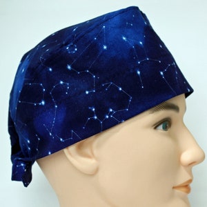 May include: A blue scrub hat with a white constellation print. The hat has a tie at the back.
