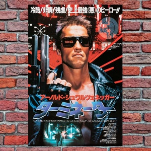 May include: A movie poster for the film "Terminator" featuring Arnold Schwarzenegger holding a gun. The poster is in Japanese and features the text "冷酷非情/残虐/史上最強(悪のヒーロー!!" and "アーノルド・シュワルツェネッガー ターミネーター".