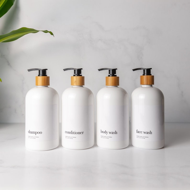 Minimal modern white shampoo, conditioner, body wash and face wash refillable dispenser bottle set with bamboo and black pump. Holds 16 fluid ounces/500 milliliters and brings a touch of spa-like feel to your primary bath, guest bath or Airbnb.