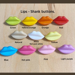 May include: A collection of colorful lip-shaped shank buttons in various shades, including green, yellow, orange, red, natural, white, blue, hot pink, pink, and light purple. The text "Lips - Shank buttons" is displayed above the buttons.