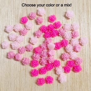 May include: Assortment of pink and white resin rose flower embellishments. Choose your color or a mix!