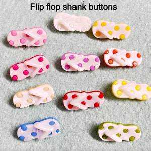 May include: Ten colorful flip flop shank buttons with polka dots. The buttons are in various colors including pink, blue, yellow, red, and green.