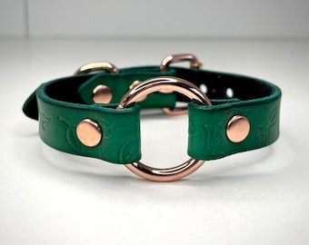 Pulsera de cuero verde con diseño de hoja y anilla en O, hecha a mano, disponible en varios colores de herrajes.