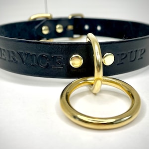 May include: Black leather collar with gold hardware and the words "SERVICE PUP" embossed on the front.