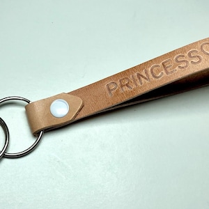 May include: A set of three ceramic mugs with a speckled, matte finish. Each mug features a different color: light blue, cream, and gray. The mugs have a simple, modern design and a comfortable handle.