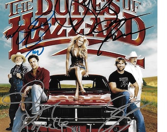 May include: A movie poster for the film "The Dukes of Hazzard" featuring the main cast members, including Johnny Knoxville, Seann William Scott, Jessica Simpson, Burt Reynolds, and Willie Nelson. The poster features a red car with the number "01" on the side.