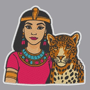 May include: Embroidered patch featuring a woman in ancient Egyptian attire with a leopard. The woman wears a pink dress, gold and turquoise jewelry, and a gold headdress. The leopard has a spotted coat and is positioned next to the woman.