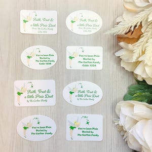 May include: White oval and rectangular stickers with green text and a fairy illustration. The text reads "Faith, Trust & a little Pixie Dust" and "You've been Pixie Dusted by The Carlton Family".