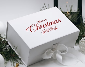May include: White gift box with a red ribbon and the words "Merry Christmas" printed on the top.