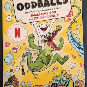 May include: A book cover for "Oddballs," a Netflix animated series. The cover features a cartoon alligator with an open mouth, a white character, and various other cartoon characters on a yellow background. The title and author names are displayed prominently.