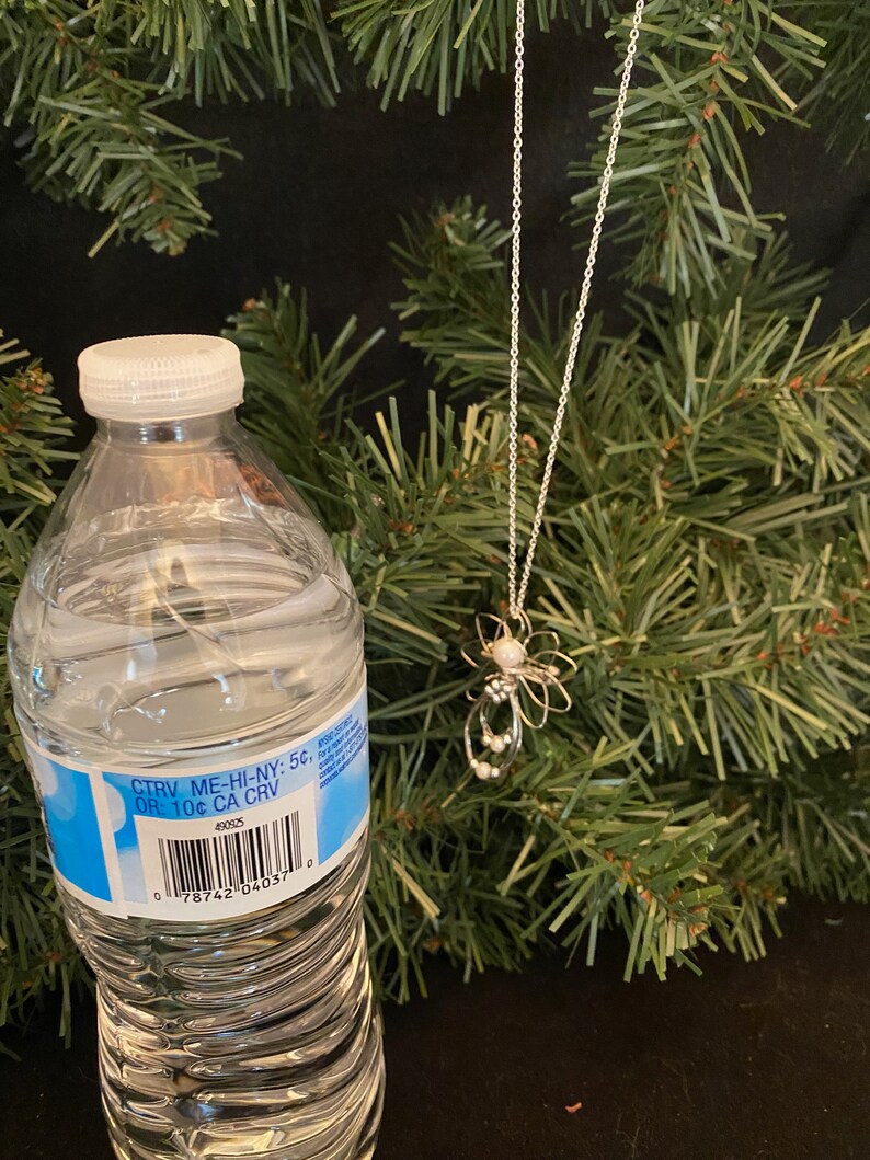 1.5-inch Handcrafted Silver Wire Angel Necklace - accented with silver and white beads. Elegant Heavenly Charm - Unique Gift for Her with a bottle.