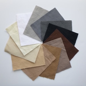 May include: A color palette of 10 fabric swatches in various shades of brown, beige, gray, and white. The swatches are arranged in a circle.