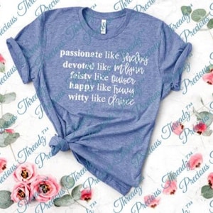 May include: A light blue t-shirt with white text that reads "passionate like Shay, devoted like Milyin, feisty like Quiser, happy like Trwy, witty like Laivce".