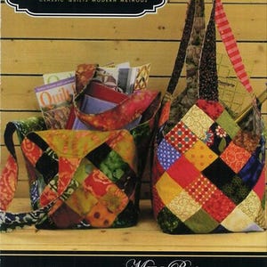 May include: A Quiltsmart printed interfacing product package featuring two handmade patchwork bags made of colorful fabric squares. The packaging includes the text Quiltsmart, Printed Interfacing, Midi Bag, Easy! Fast! Smart!, and additional descriptive text.