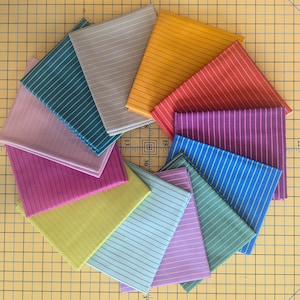 May include: A collection of colorful fabric squares arranged in a circular pattern. Each square features a different color, including teal, gray, yellow, red, purple, blue, pink, green, and light blue, with thin, vertical stripes. The fabrics are neatly folded.