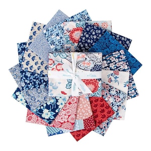 May include: A collection of fabric squares in shades of blue, red, and white, arranged in a circular pattern. The fabrics feature floral and geometric designs. A stack of fabric squares is tied with a white ribbon that reads "Riley Blake Designs".