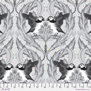 May include: A fabric pattern featuring a repeating design of puffins with outstretched wings, set against a backdrop of stylized gray leaves and floral elements. The puffins are black, white, and gray, with colorful dots scattered throughout. The fabric is measured in inches.