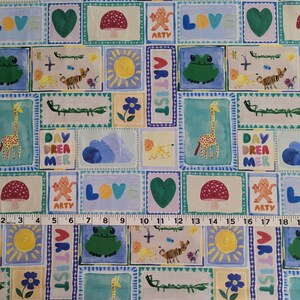 Op de afbeelding: Een kleurrijke stof met een herhalend patroon van vierkanten. Elk vierkant bevat een andere illustratie, waaronder een giraffe, een kikker, een paddenstoel, een hart, een zon, een wolk en de woorden "Day Dreamer", "Artist" en "Love".