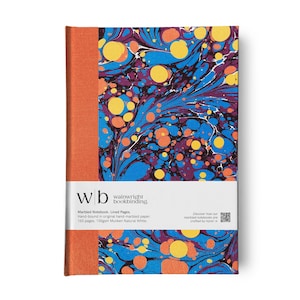 May include: A hardbound notebook with a marbled cover in shades of blue, purple, and yellow. The spine is orange. The notebook has a white band with the text "wb wainwright bookbinding."