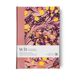 May include: A hardback notebook with a marbled pattern in purple, yellow, and orange. The spine is a solid pink colour. A white band across the middle features the text "wb wainwright bookbinding."