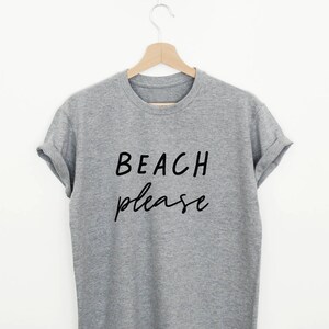 May include: A gray t-shirt with the text "BEACH please" printed in black.