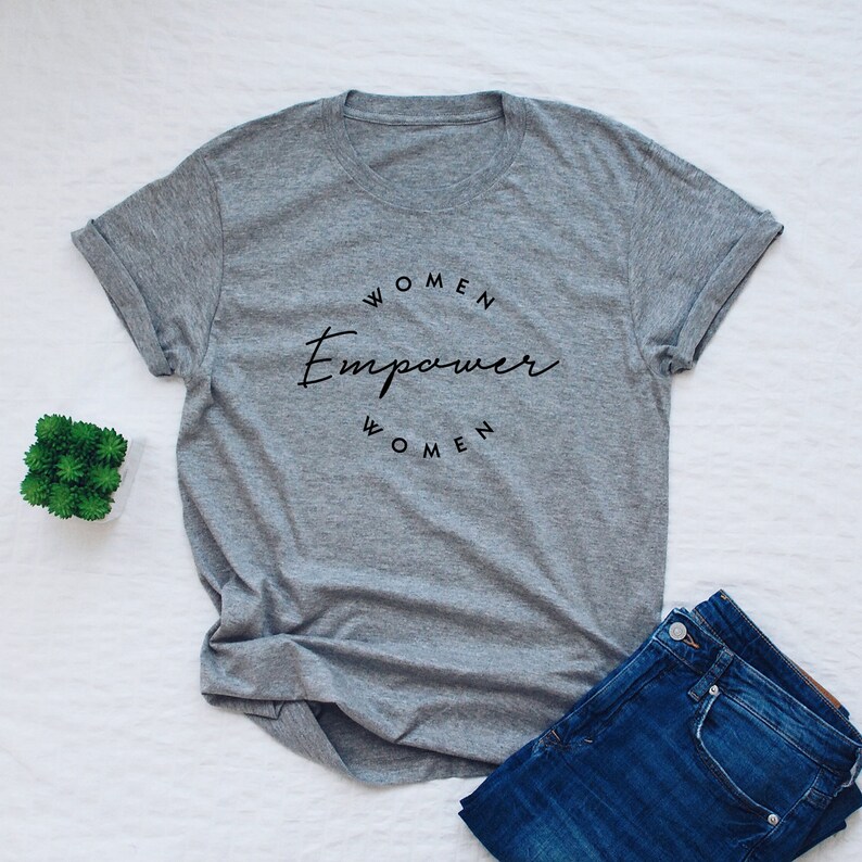 May include: Gray t-shirt with the text "Women Empower Women" in a circle.