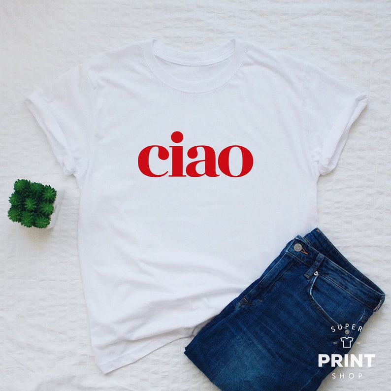 May include: White t-shirt with the word "ciao" printed in red.