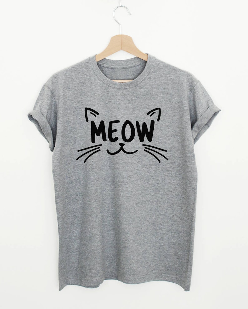 May include: Gray t-shirt with a black cat face and the word "MEOW" printed on the front.