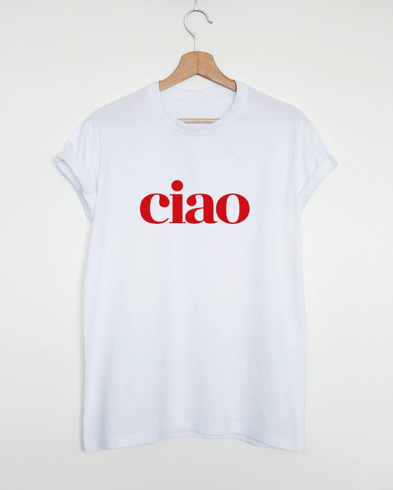 May include: White t-shirt with the word "ciao" printed in red.