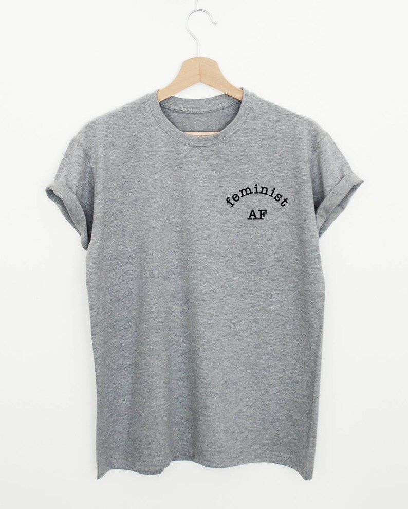 May include: A gray t-shirt with the text "feminist AF" printed on the front.
