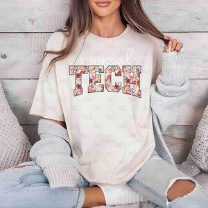 May include: A white t-shirt with a floral design that says "surgical tech" in pink, red, and orange.