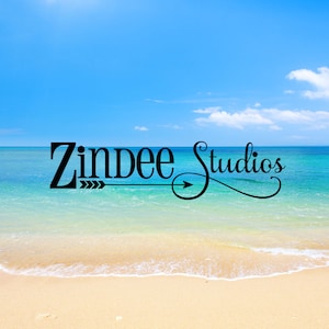 May include: A beach scene with a blue sky and white clouds. The words "Zindee Studios" are written in black with a stylized arrow in the middle.