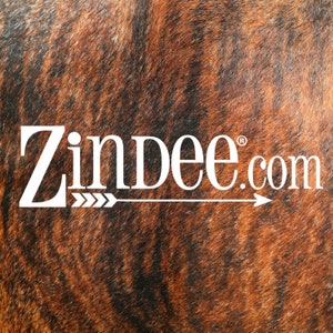 May include: White text on a brown and black cowhide background reads "Zindee.com" with an arrow pointing to the right.