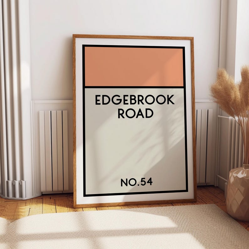 May include: A framed print with a peach colored rectangle at the top and a white rectangle at the bottom. The text "EDGEBROOK ROAD NO. 54" is printed in black on the white rectangle.