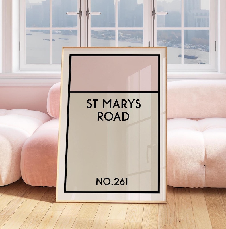 May include: A framed print with a pink and beige color scheme. The print features the text "St. Mary's Road" and "No. 261".