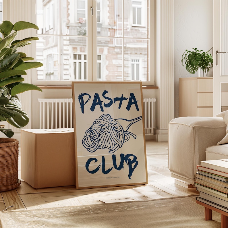 May include: A framed poster with a blue illustration of a plate of pasta and the text "PASTA CLUB" in blue lettering.
