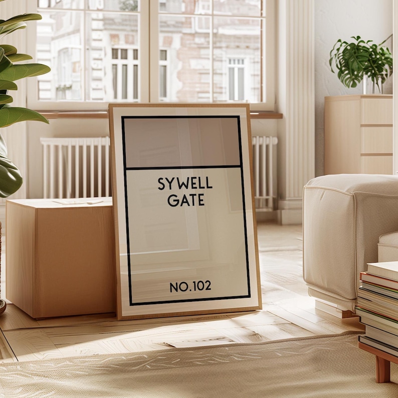May include: A framed print with a beige and white background. The print features the text "SYWELL GATE NO.102" in black.