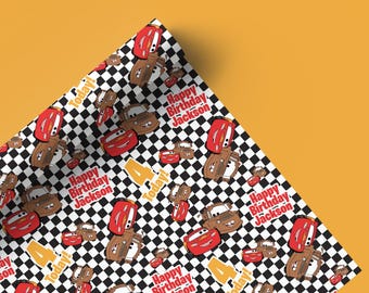 May include: Wrapping paper with a repeating pattern of cartoon cars in red and brown, set against a black and white checkered background. The text "Happy Birthday Jackson" and "Today!" are also featured.