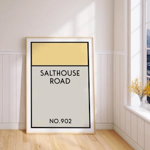 May include: A framed print with a yellow and gray color scheme. The print features the text "Salthouse Road" and "No. 902".