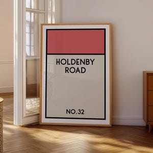 May include: A framed print with a red, white, and gray color scheme. The print features the text "Holdenby Road No. 32".
