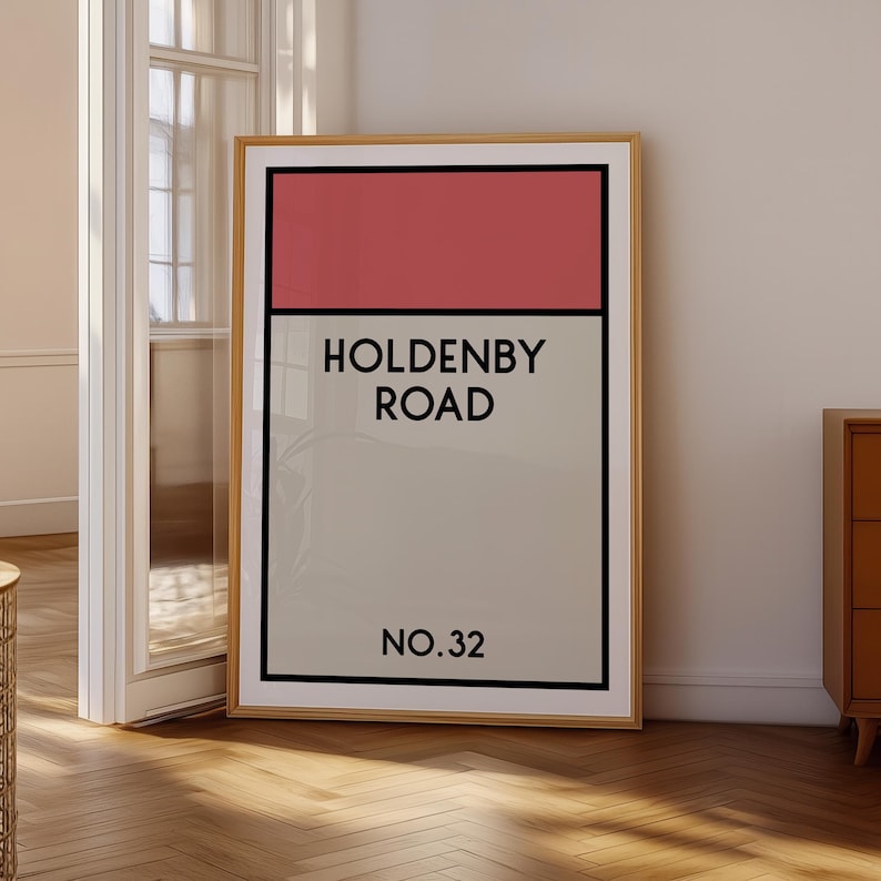 May include: A framed print with a red, white, and gray color scheme. The print features the text "Holdenby Road No. 32".