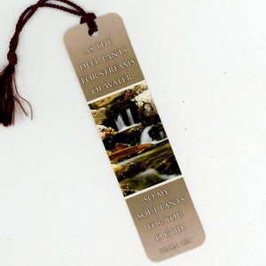 May include: A beige bookmark with a brown tassel. The bookmark features a scenic image of a waterfall and text from Psalm 42:1: "As the deer pants for streams of water. So my soul pants for you, O God."