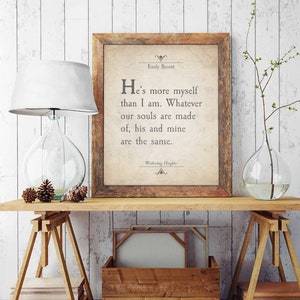 May include: A framed print with a quote from Emily Bront&euml;'s novel *Wuthering Heights*. The quote reads: "He's more myself than I am. Whatever our souls are made of, his and mine are the same."