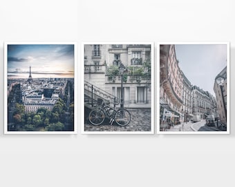 May include: A set of three framed photographs depicting different views of Paris, France. The first photo shows a panoramic view of the city with the Eiffel Tower in the distance. The second photo shows a street scene with a bicycle parked in front of a building. The third photo shows a curved street with buildings on both sides.