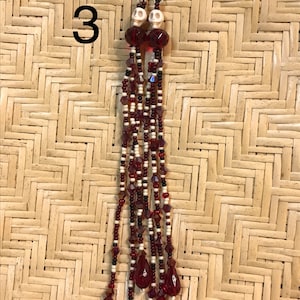 Beaded fringe earrings with skull detail