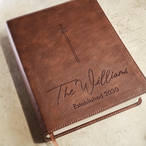 Elegant leather NIV Bible personalized for wedding ceremony with custom engraving on front cover. Christian wedding guest book alternative, family Bible keepsake, engraved religious wedding gift for couple.