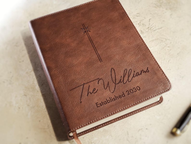 Elegant leather NIV Bible personalized for wedding ceremony with custom engraving on front cover. Christian wedding guest book alternative, family Bible keepsake, engraved religious wedding gift for couple.